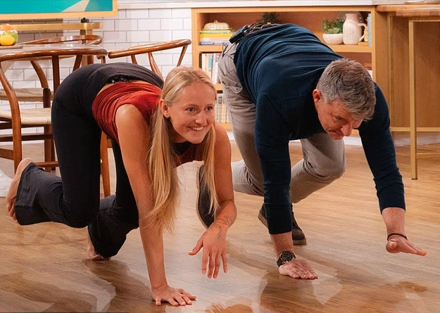  Alexia Kraft performing a high-altitude athletic leap during a quadrobics session on a grass field.