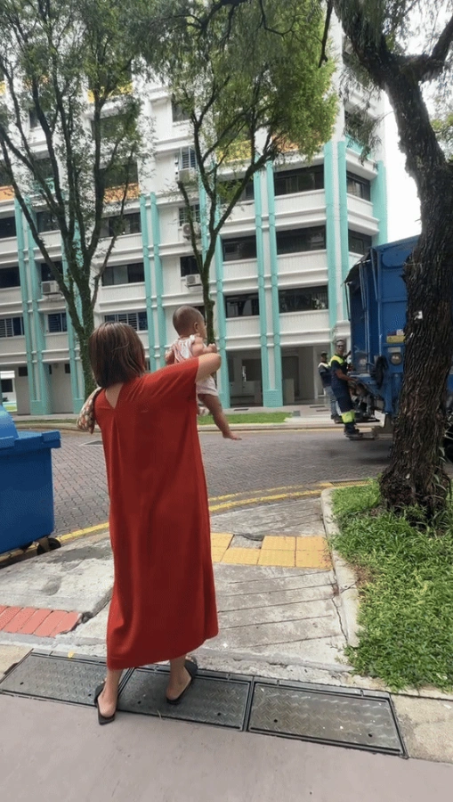showing the garbage truck approaching the family in a Singapore heartland.