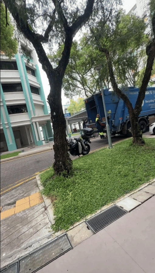 Close-up of a smiling waste management worker in Singapore looking at his child with pride