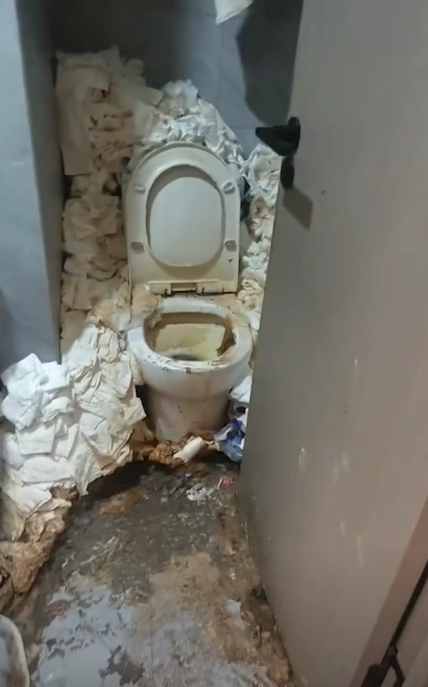 Extreme hoarding and trash accumulation in a hotel room after a two-year stay.