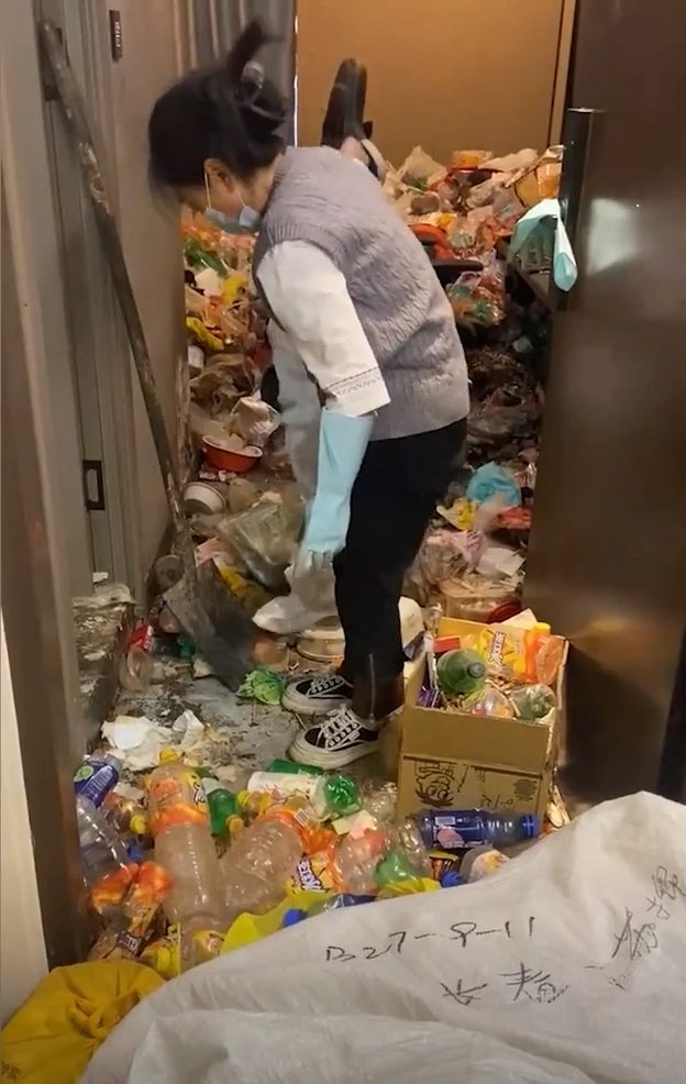 Hundreds of empty plastic water bottles and takeaway containers scattered in a room.