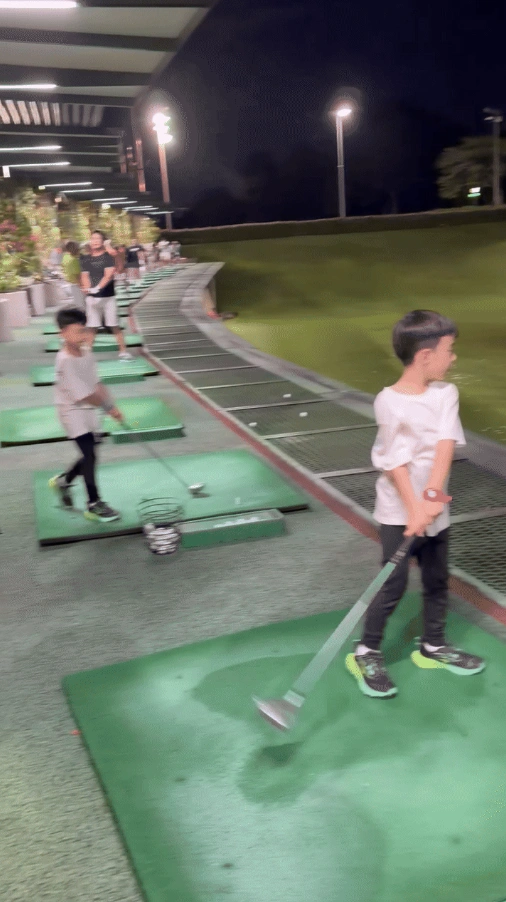  Close-up of a white golf ball inside the cup at the 3rd hole of Mandai course.