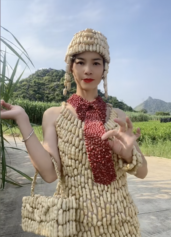  Artistic fashion details featuring red chili peppers and various farm vegetables integrated into clothing.