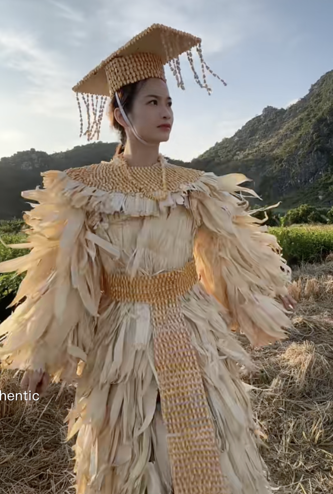 A close-up of a fashion outfit made from vibrant green cabbage leaves and vegetable vines.