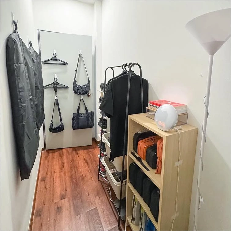 Compact workstation and storage area inside a micro-apartment room.