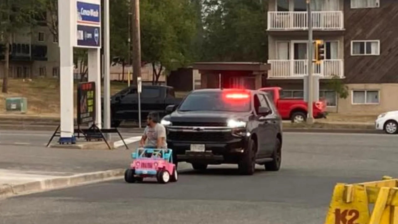  Pink electric Barbie Jeep pulled over by police on a public road at night.