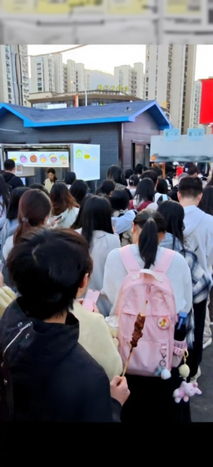 A candid photo of a Singaporean hawker vendor smiling while working at their food stall.